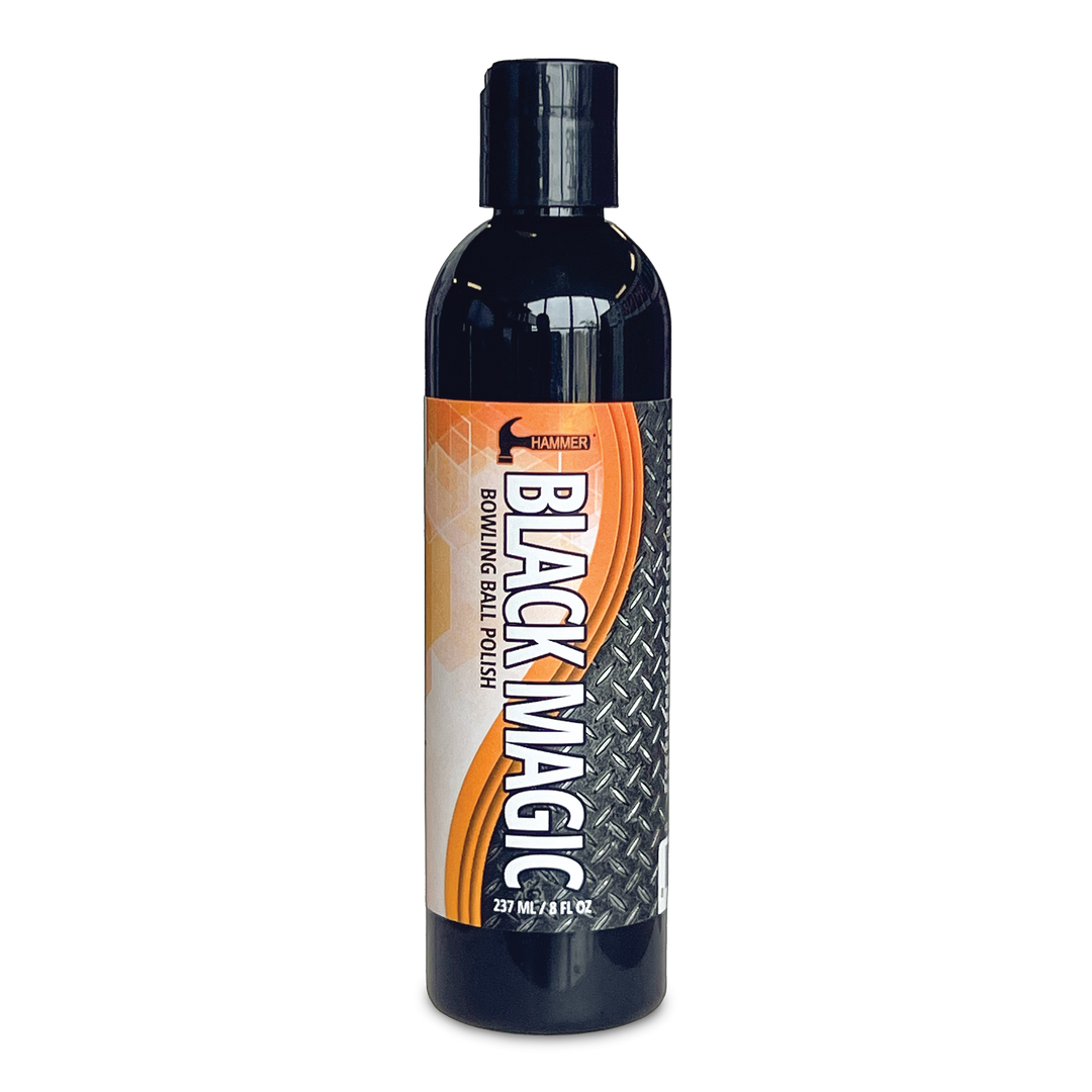 An eight fluid ounce black bottle with an orange and black label with "Black Magic" and other information printed on it.