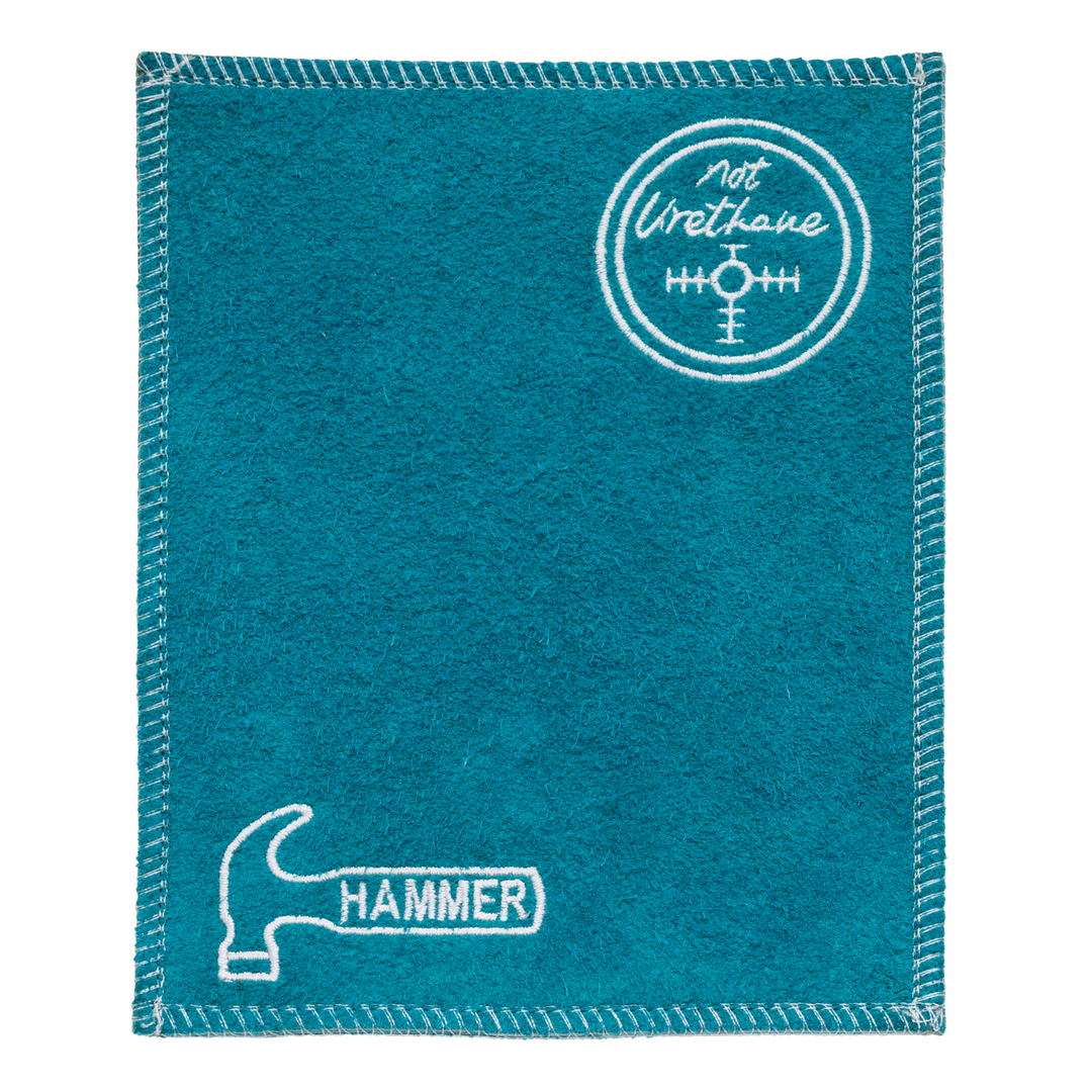 A blue shammy pad with white stitching around all edges and the Hammer logo embroidered in white in the lower left corner along with the "Not Urethane" center of gravity logo embroidered in white in the upper right corner.