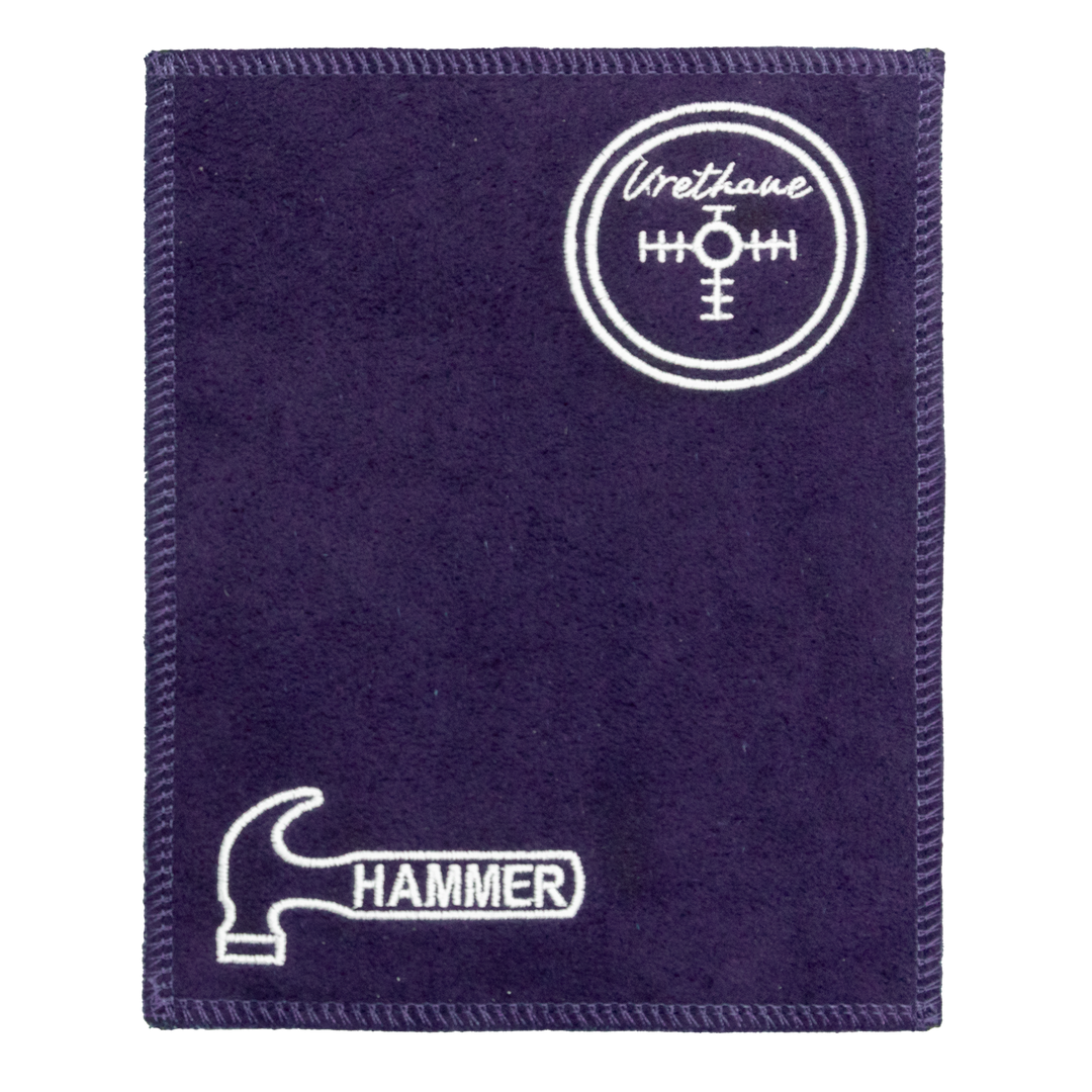 A purple shammy pad with purple stitching around all edges and the Hammer logo embroidered in white in the lower left corner along with the Urethane center of gravity logo embroidered in white in the upper right corner.