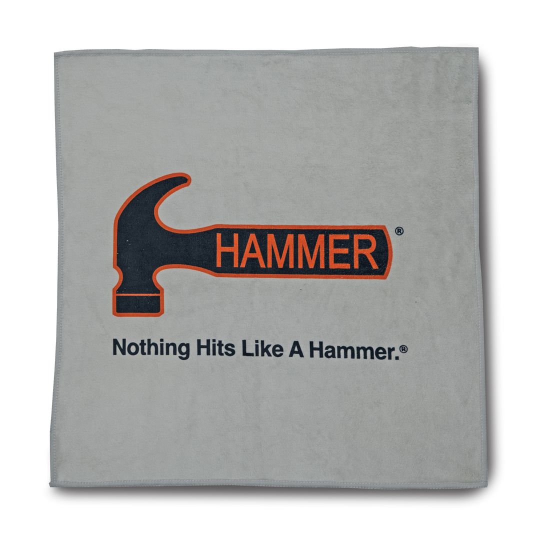 A gray colored premium towel with the Hammer brand logo and the slogan 'Nothing Hits Like A Hammer.'