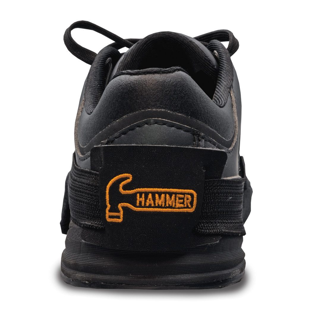 A black shoe slider with a small orange Hammer logo embroidered on the strap that goes around the back of the shoe.