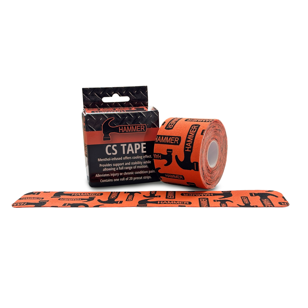 Hammer CS Tape box and tape roll sitting next to each other. The tape being orange with black Hammer logos randomly printed on the surface. A piece of the tape laying flat in front of the box and tape roll.