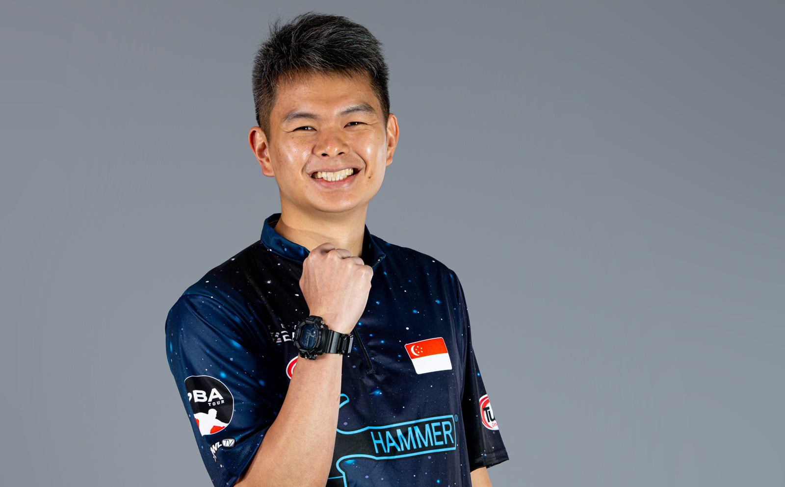 Darren Ong Portrait with fist up in celebration.