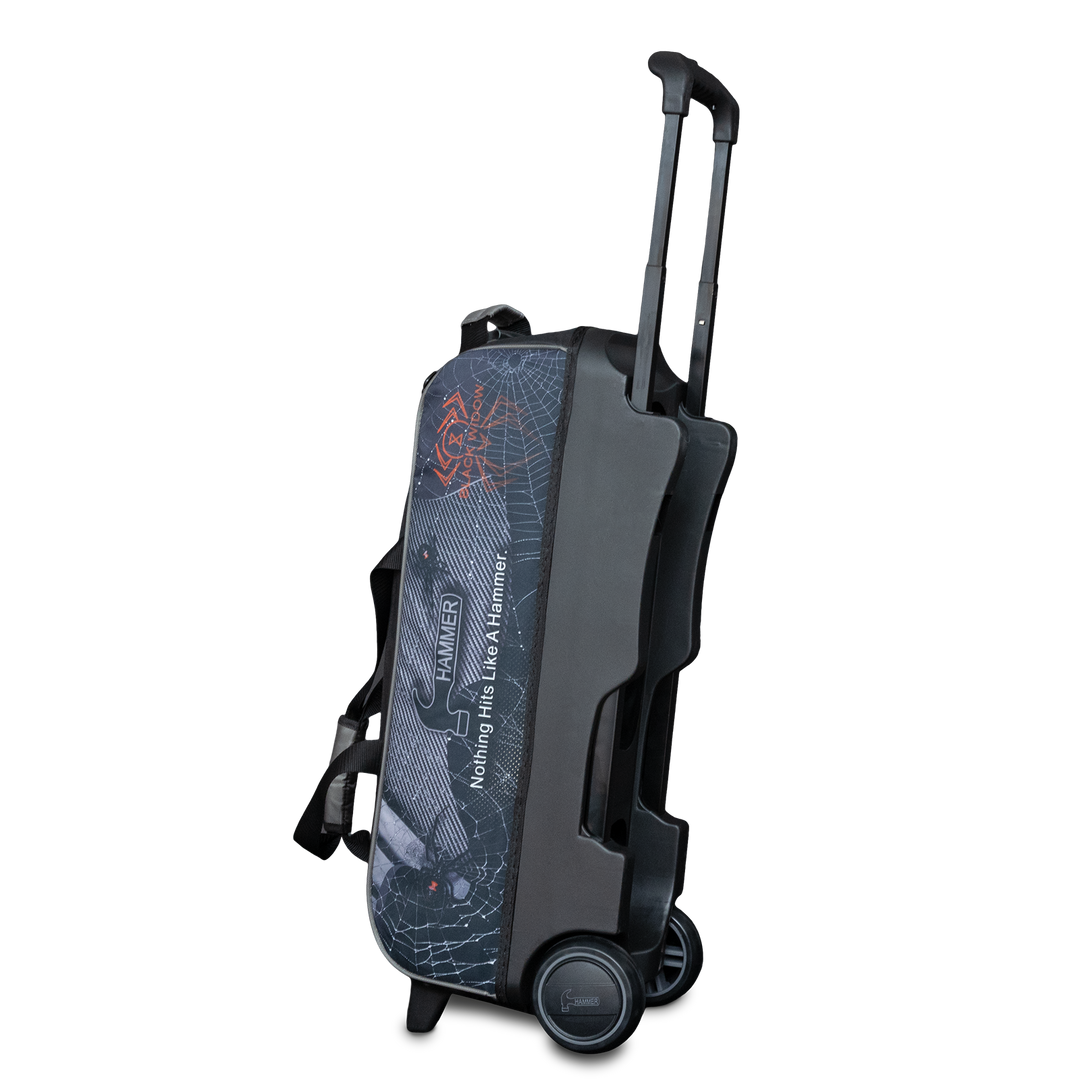 The Hammer Black Widow Hybrid Triple Roller in the upright position with the handle extended with Black Widow graphics printed on the side panel in a three quarter view with the base showing.