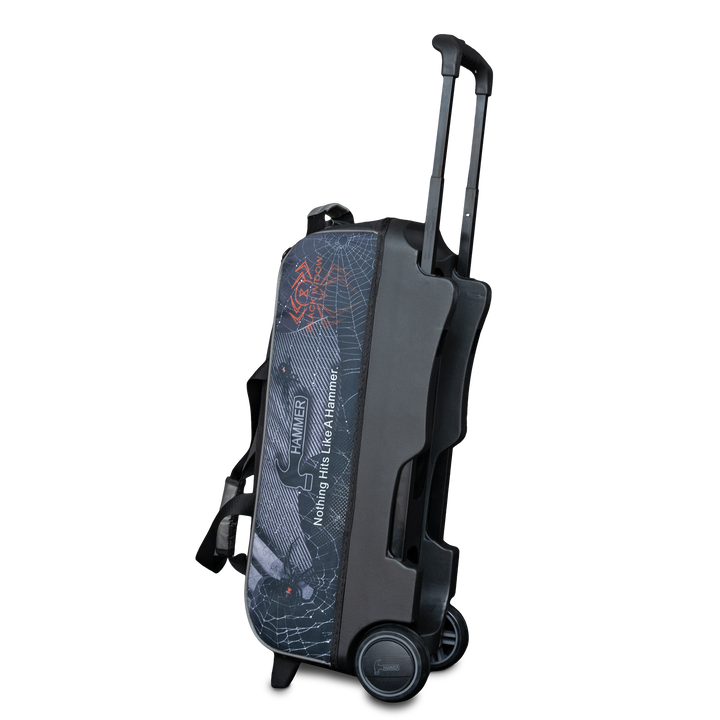 The Hammer Black Widow Hybrid Triple Roller in the upright position with the handle extended with Black Widow graphics printed on the side panel in a three quarter view with the base showing.