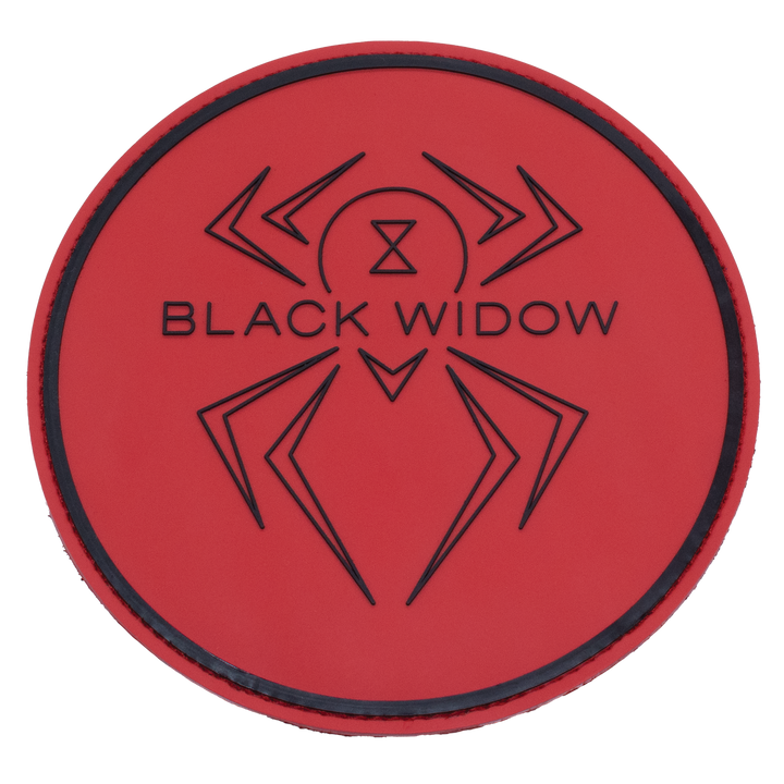 A round shammy pad with a red, rubber front with the Black Widow logo and a thicker line near the edge of the circle shape molded in black into the rubber.