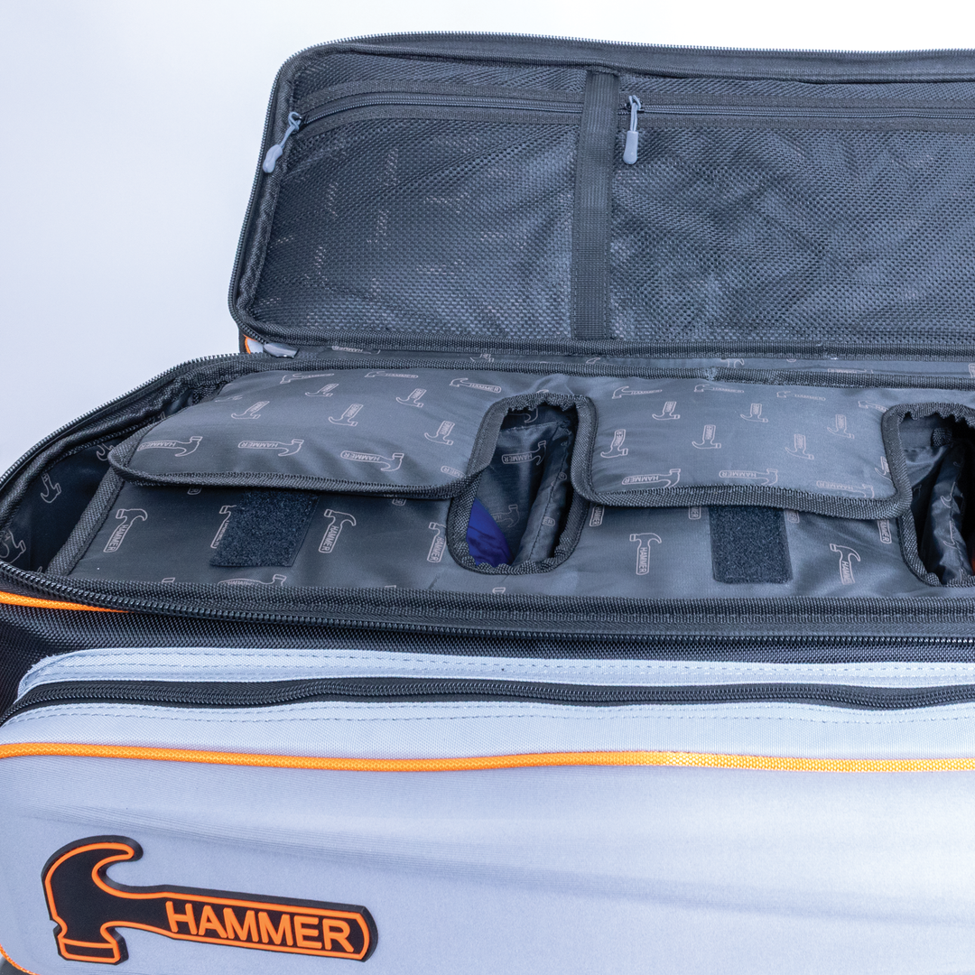 Hammer Gantlet Triple Roller Grey interior ball compartment with lining printed with Hamnmner logos and zippered mesh pockets.