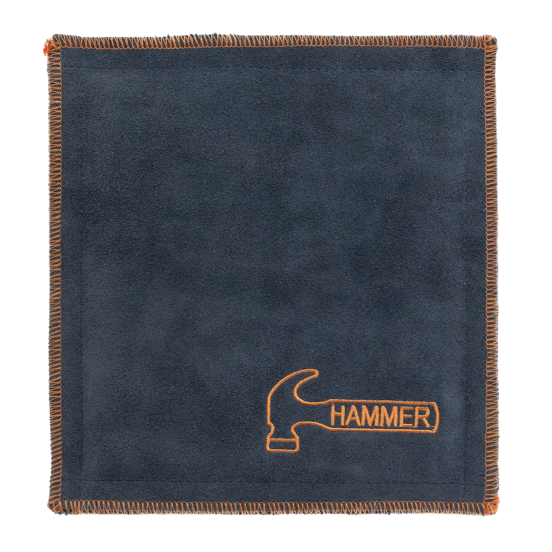 A black premium shammy pad with orange stitching around all edges and the Hammer logo embroidered in orange in the lower right corner.