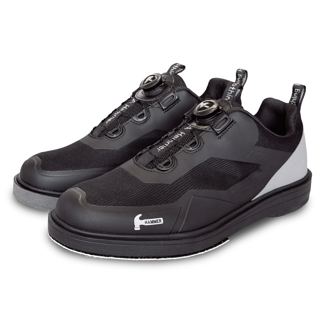 A black pair of shoes with grey accents in a three-quarter view facing left.