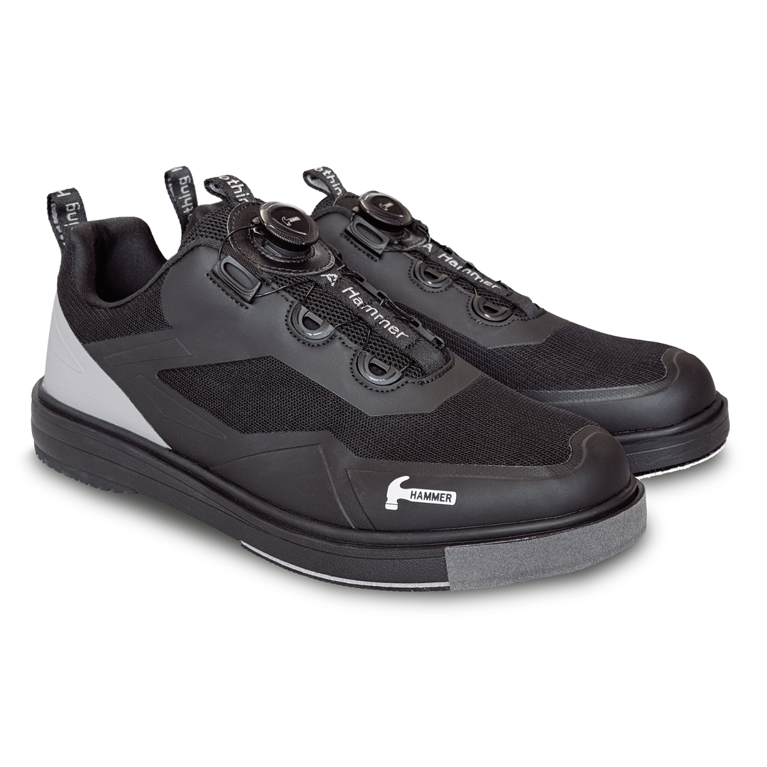 A black pair of shoes with grey accents in a three-quarter view facing right.