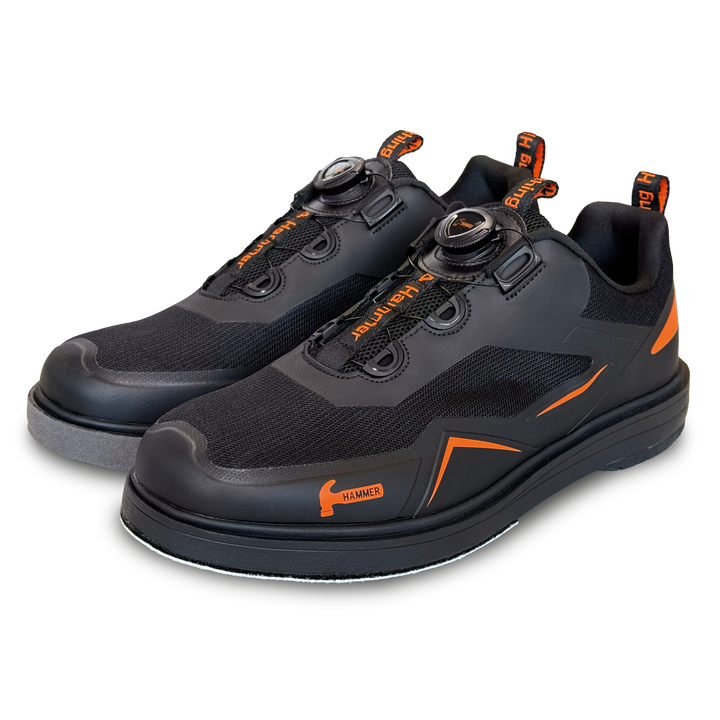 A black pair of shoes with orange accents in a three-quarter view facing left.