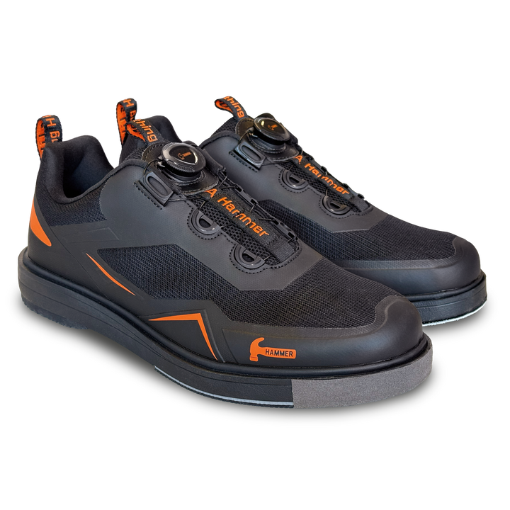 A black pair of shoes with orange accents in a three-quarter view facing right.